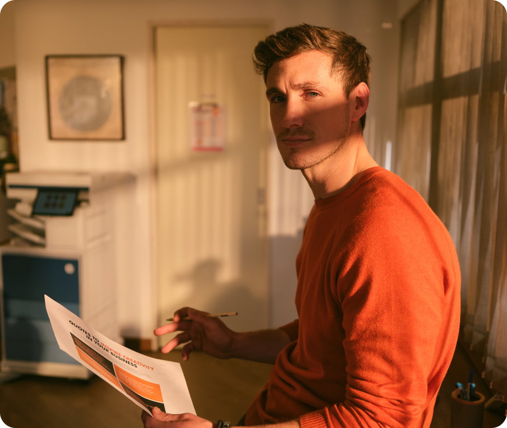 Man holding colorful printed paper