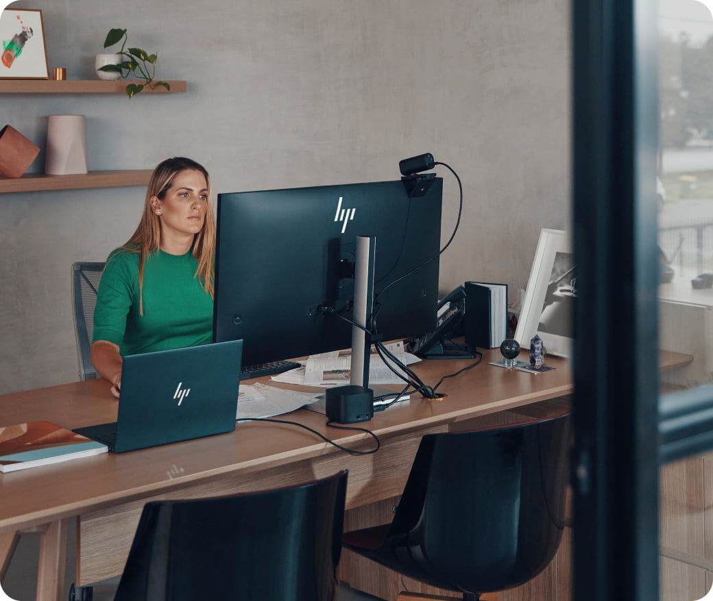 Woman using a laptop in a modern office, representing the future of work and digital transformation