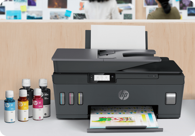 HP color printer with HP ink bottles on the left.